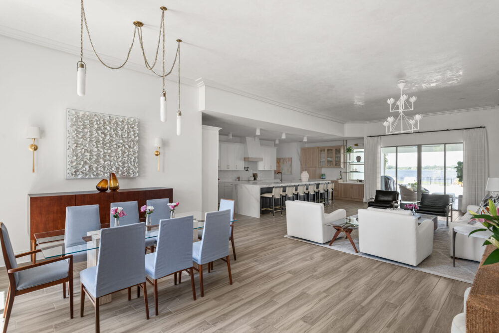 Winter Garden whole-home interior design and remodel &mdash; open plan with dining, living, and kitchen flowing to a lake view, in whites and pale wood