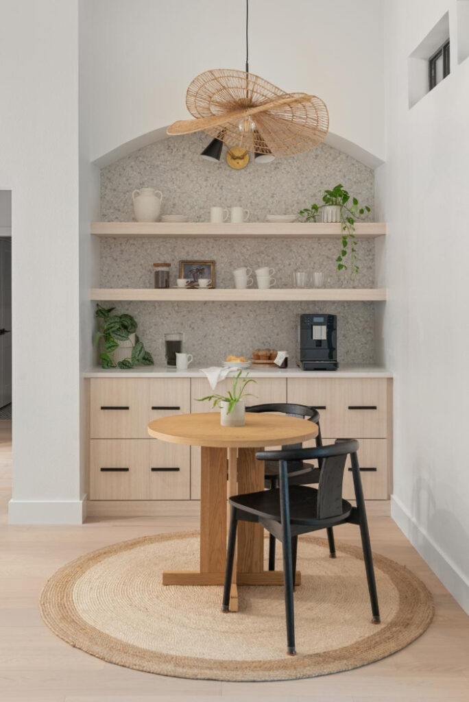 Built-in coffee and beverage nook with an arched niche, floating light wood shelves, and a terrazzo-look tile backsplash in a Celebration FL home remodel by KBF Design Gallery