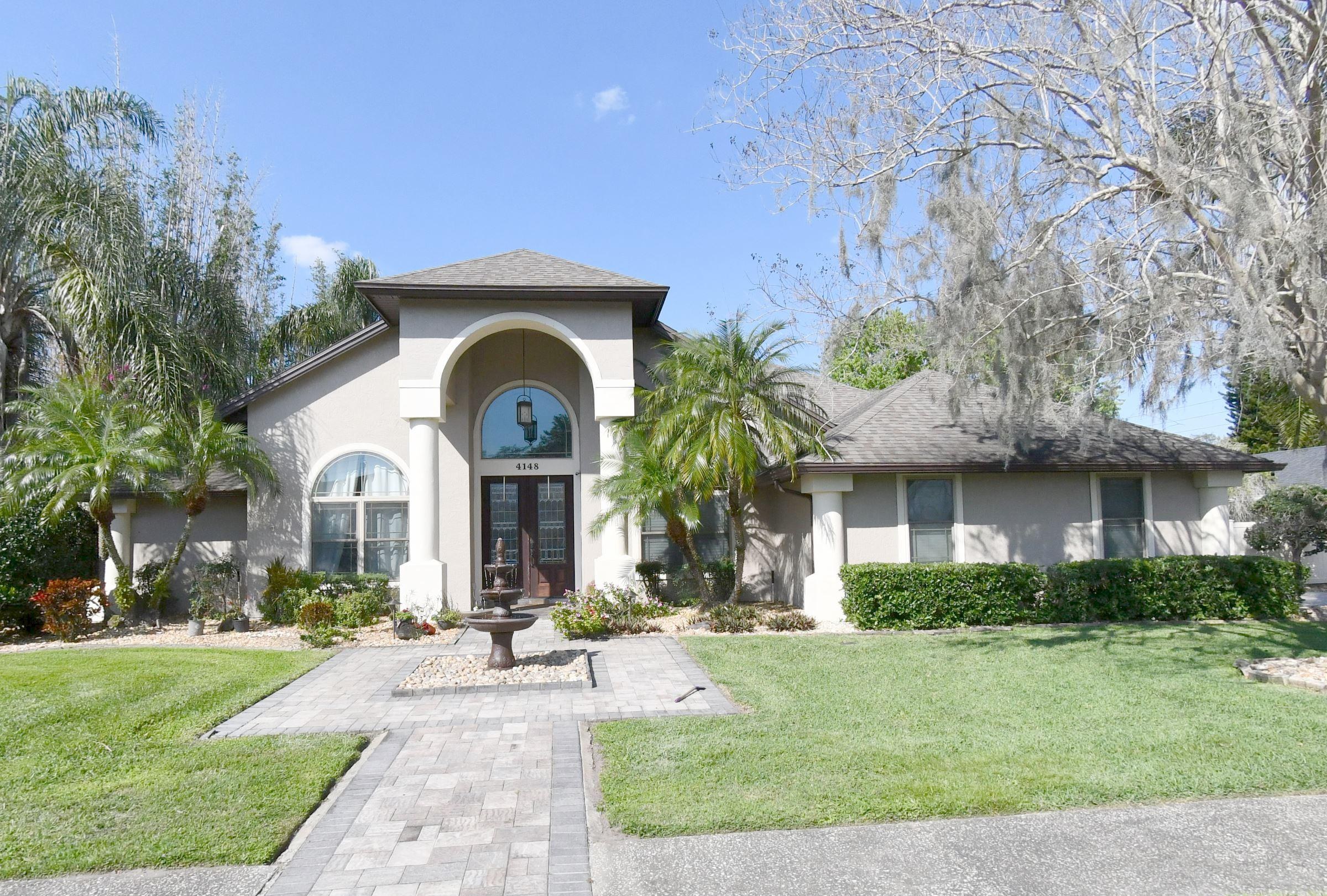 Exterior of the Aughton Court home in Winter Springs, Florida &mdash; an interior remodel by KBF Design Gallery set both the street price record ($680,000) and the price-per-square-foot record ($271/sqft) in 2022.