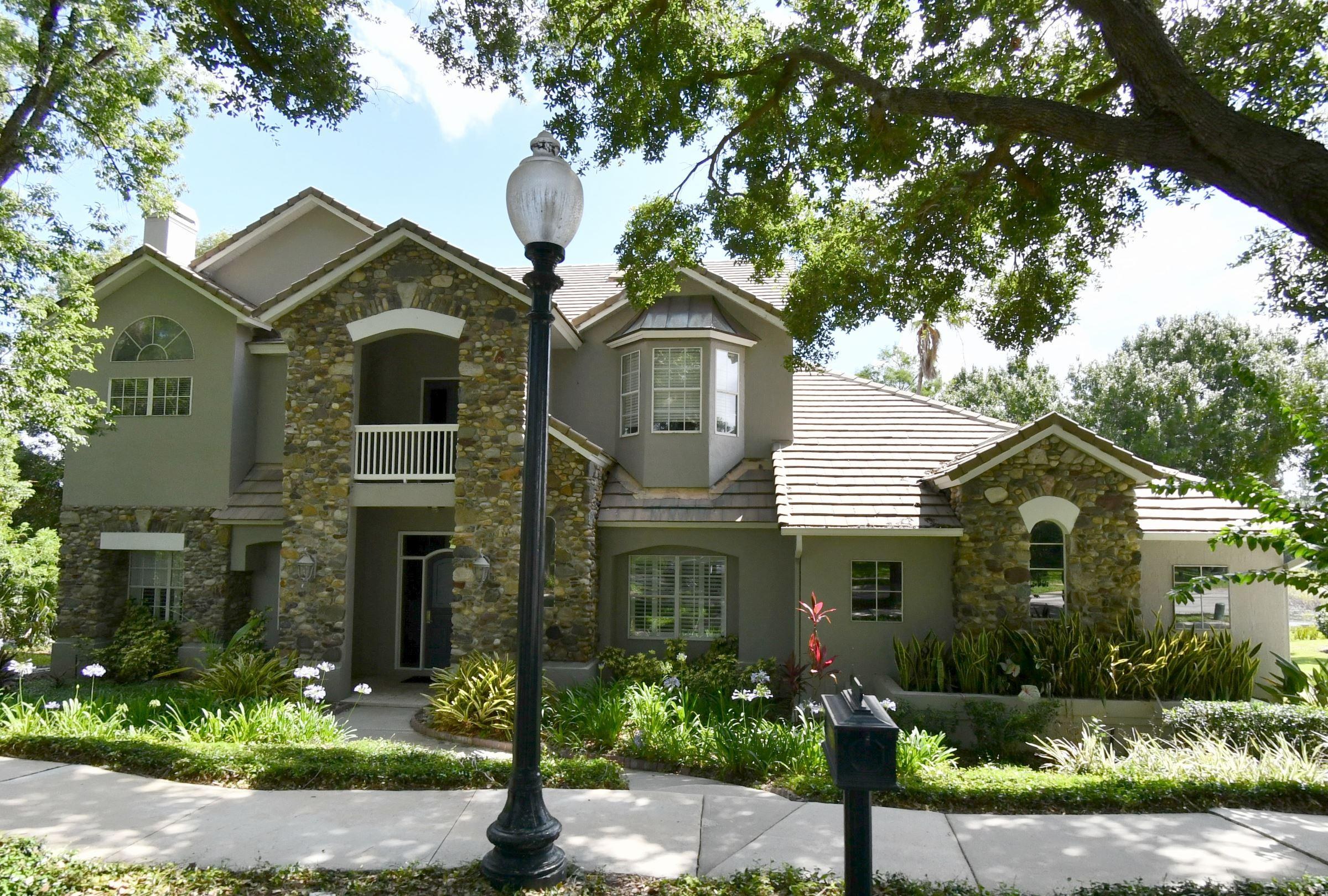 Exterior of the Cricklewood Terrace home in Heathrow, Florida, directly on Island Lake &mdash; a KBF Design Gallery upstairs bath renovation helped this property sell for $1,170,000, ranking it #3 of all 49 homes ever sold on the street.