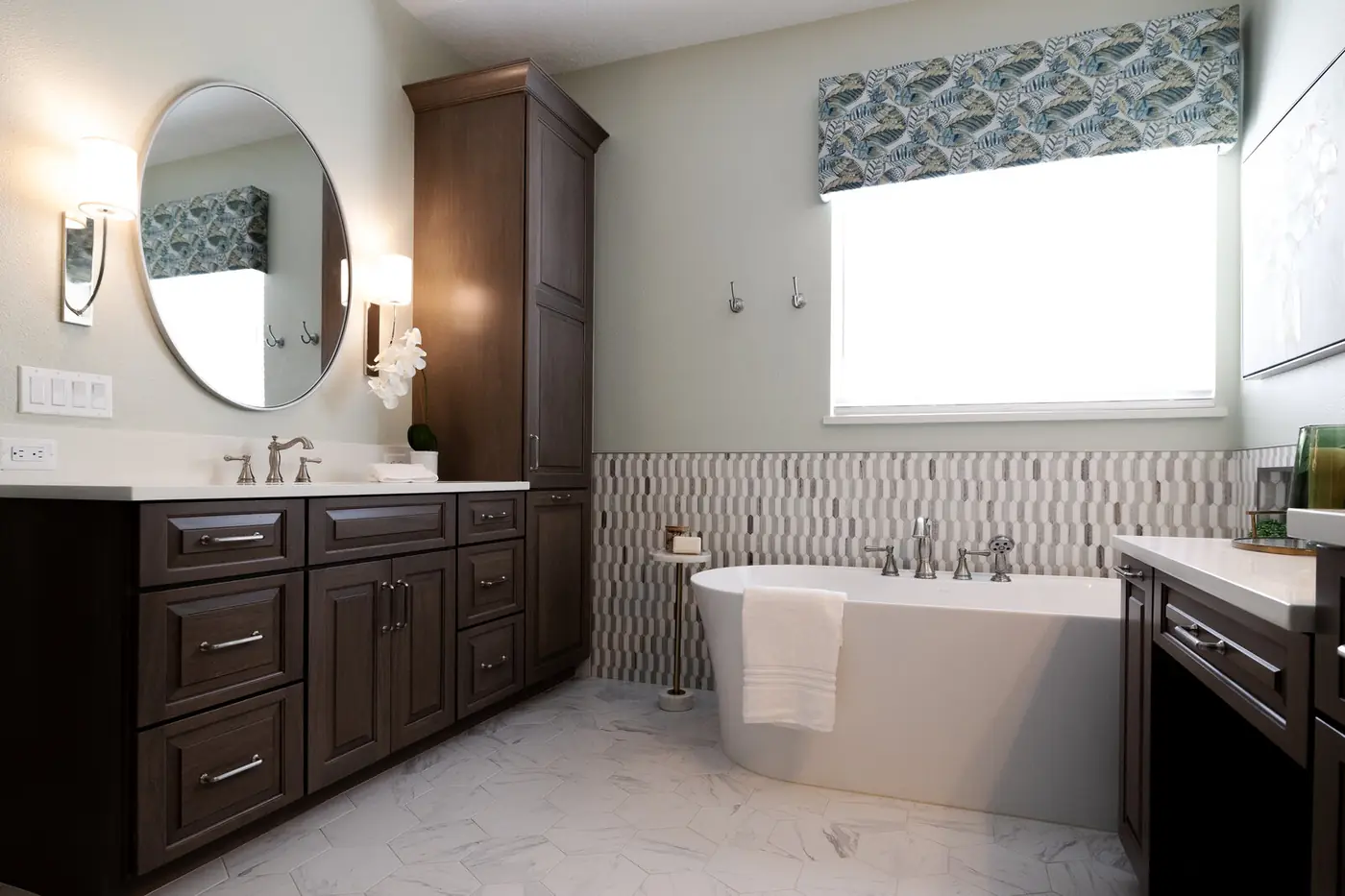 The master bath at completion &mdash; freestanding tub, patterned tile wainscot, dark wood vanities and custom valance
