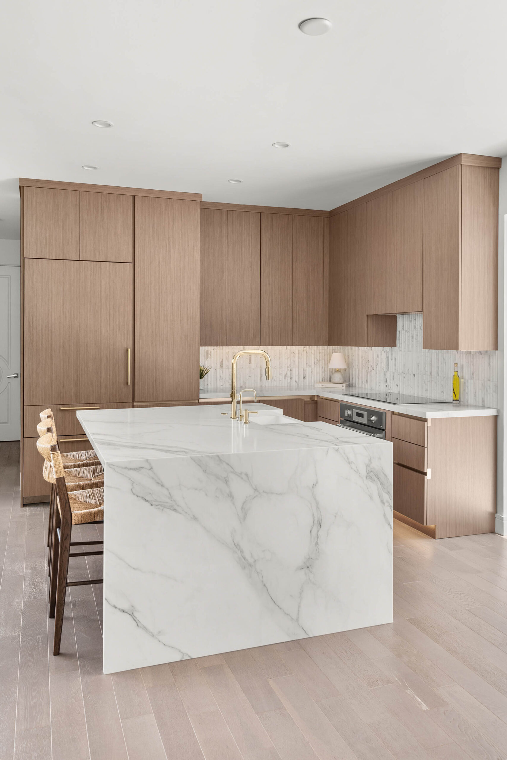 Baldwin Park kitchen remodel with white oak cabinetry and a marble waterfall island by KBF Design Gallery