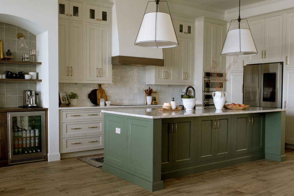 Baldwin Park kitchen remodel with a sage green island, cream cabinetry, and arched beverage station by KBF Design Gallery