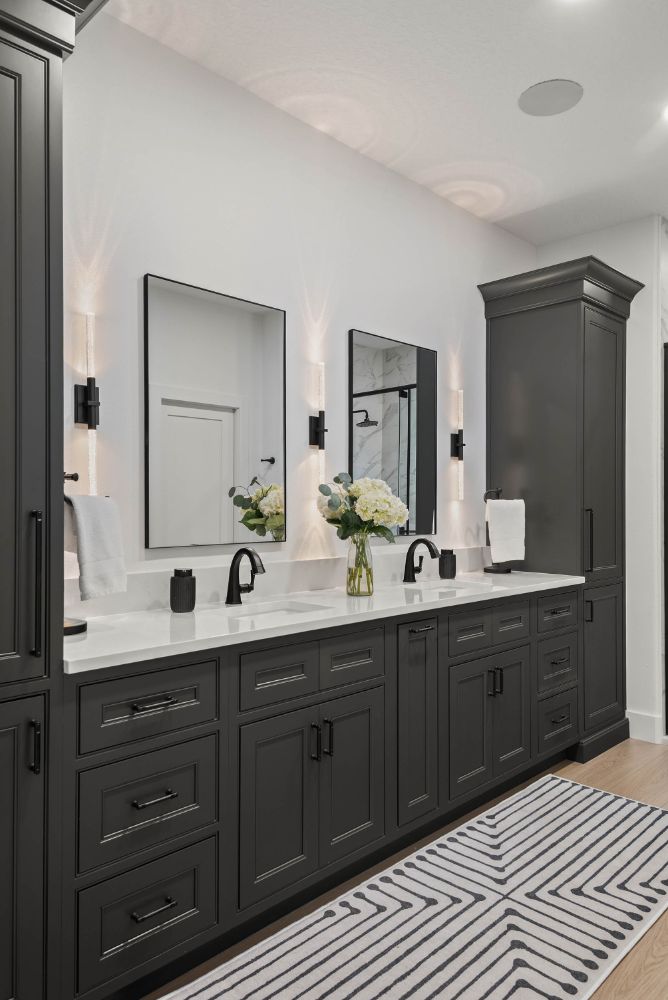 Charcoal double vanity with matte black fixtures in a Lake Mary primary bathroom remodel by KBF Design Gallery