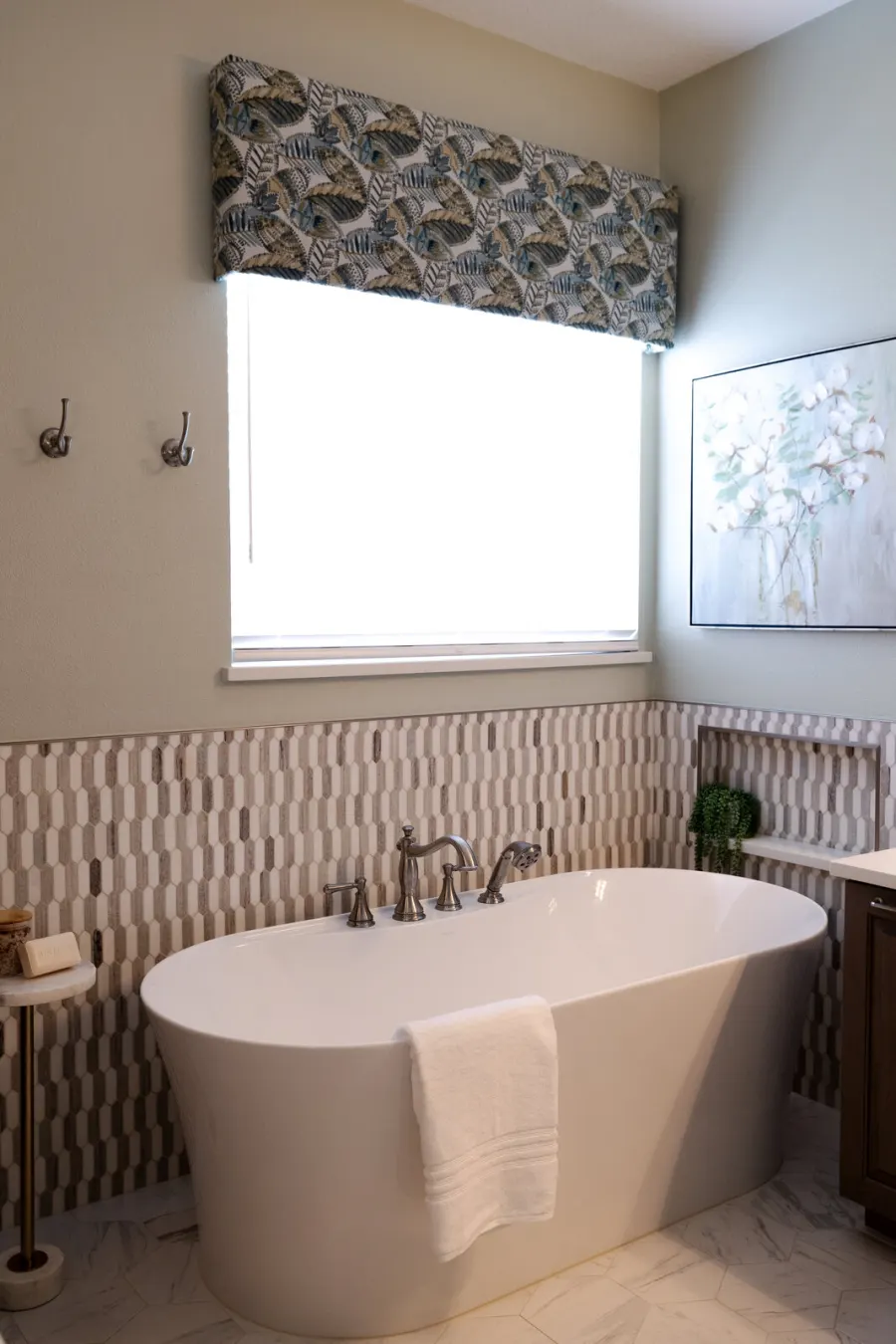 The freestanding tub beneath the window