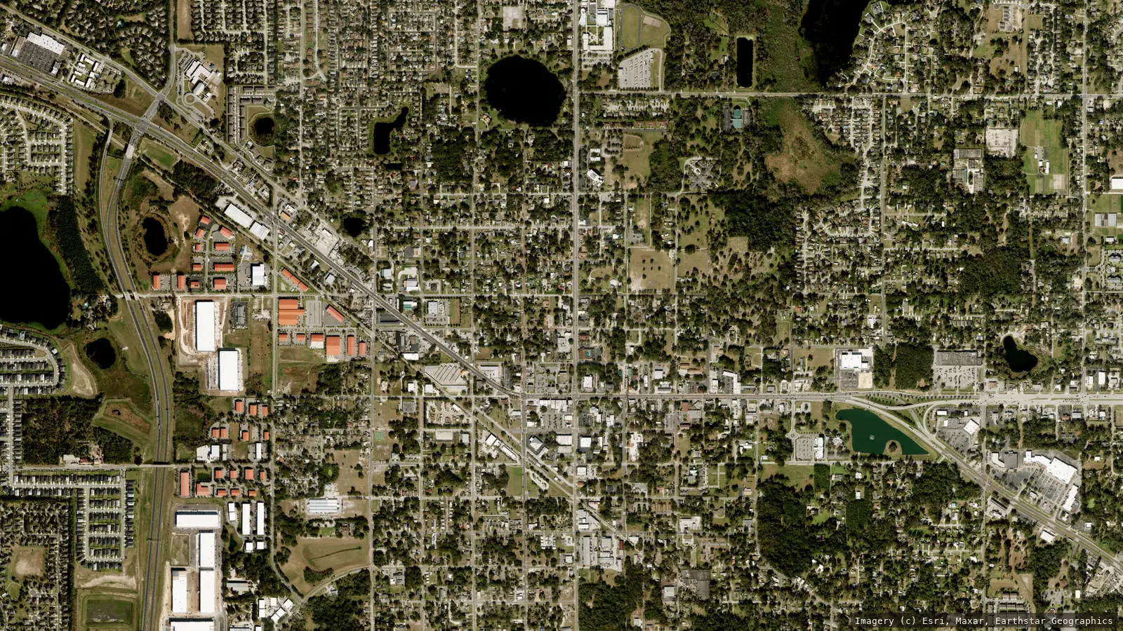 Satellite view of Apopka, Florida from neighborhood altitude &mdash; the US-441 corridor running through the downtown street grid. Imagery &copy; Esri, Maxar, Earthstar Geographics