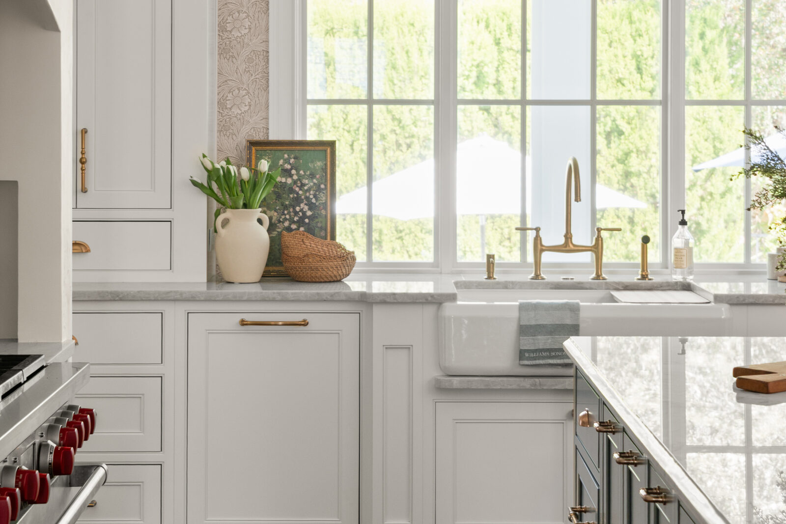 Farmhouse sink and brass bridge faucet under the garden window in the Sage Hearth kitchen