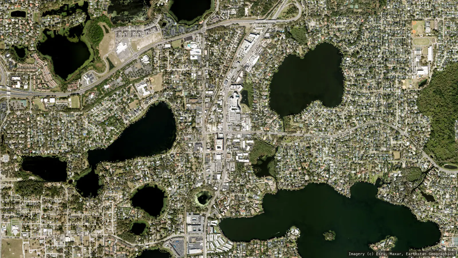 Satellite view of Maitland, Florida from neighborhood altitude &mdash; the US 17-92 corridor through historic downtown with Lake Sybelia, Lake Lily and the lake chain. Imagery &copy; Esri, Maxar, Earthstar Geographics