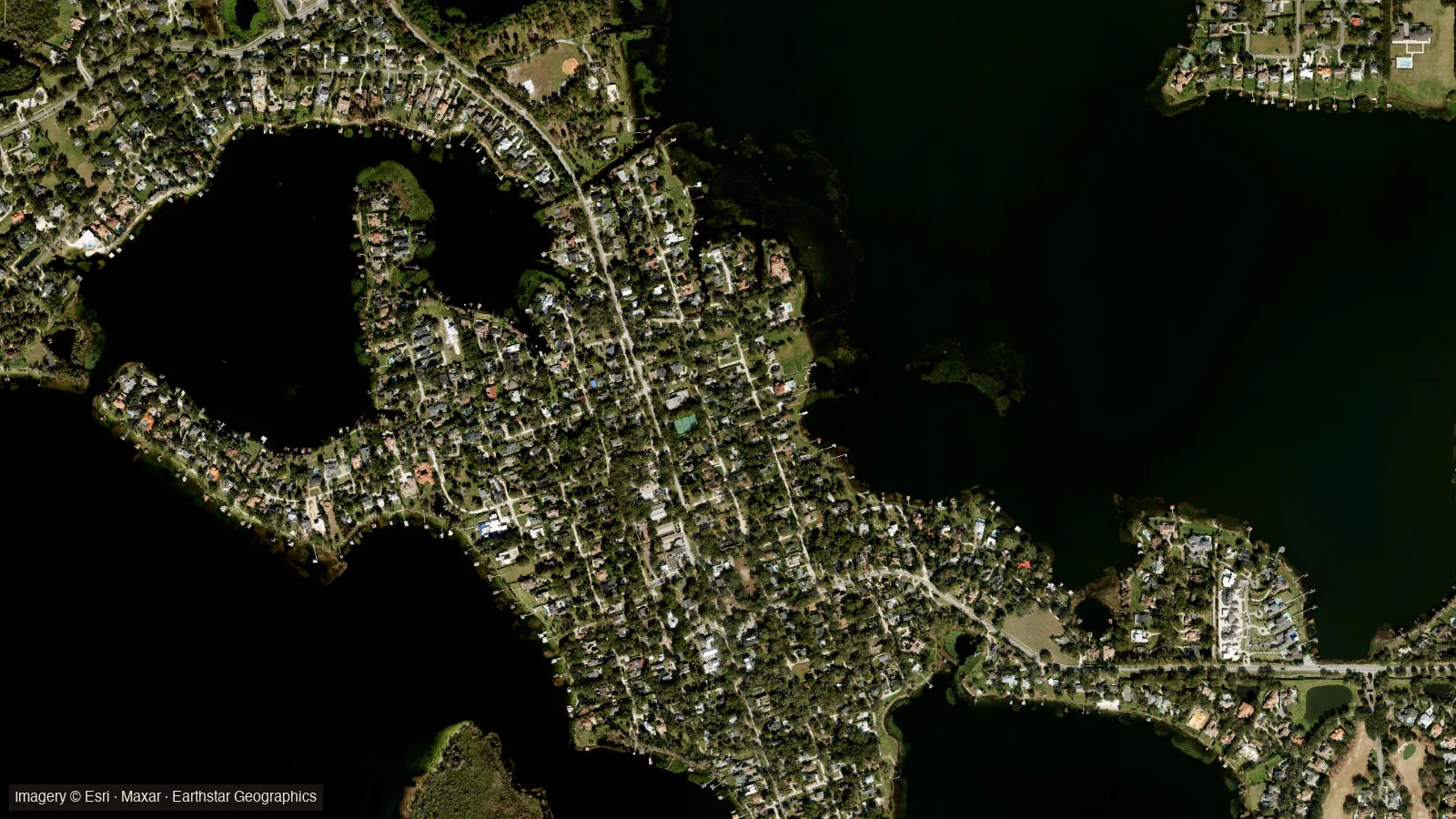 Satellite view of Windermere (often typed Windemere), Florida &mdash; the downtown historic district's street grid between Lake Down and Lake Butler on the Butler Chain of Lakes. Imagery &copy; Esri, Maxar, Earthstar Geographics