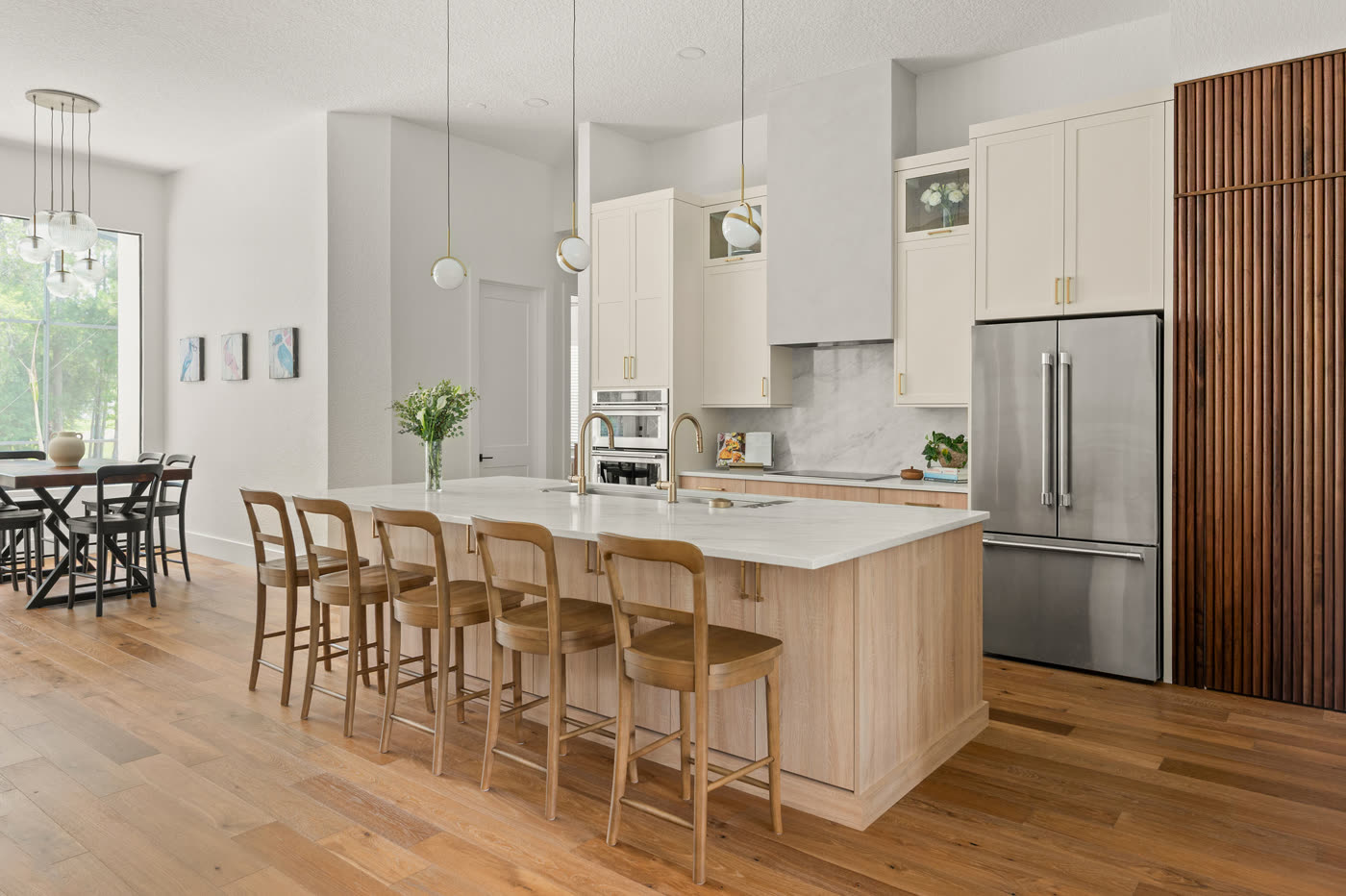 Wide-plank wood flooring in a warm light tone running from the remodeled Orlando kitchen through to the dining area