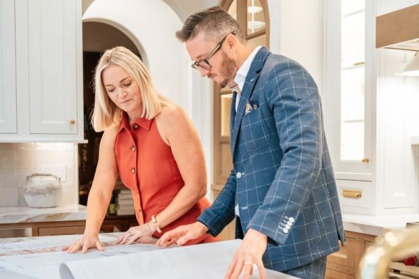 KBF Design Gallery's owners looking over a plan set for a remodel